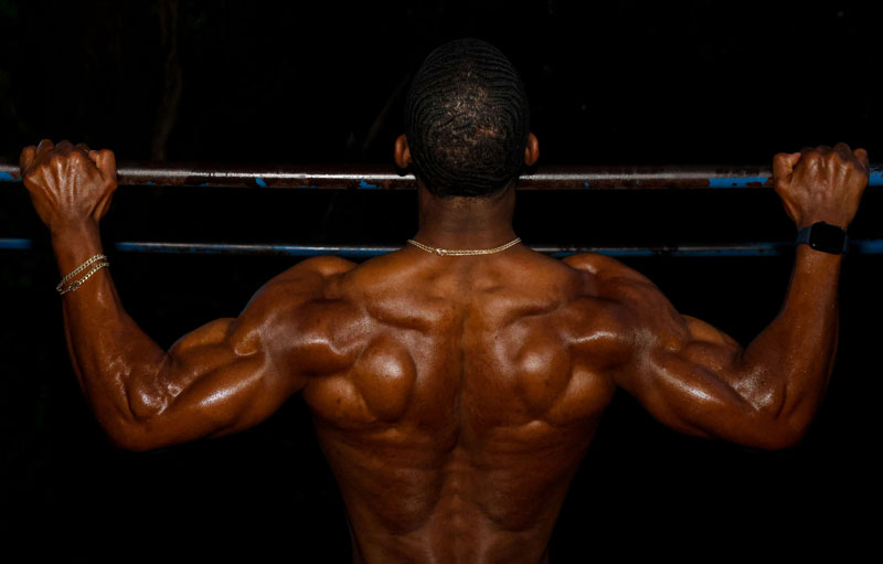 A photo fo the coach performing a chin up.